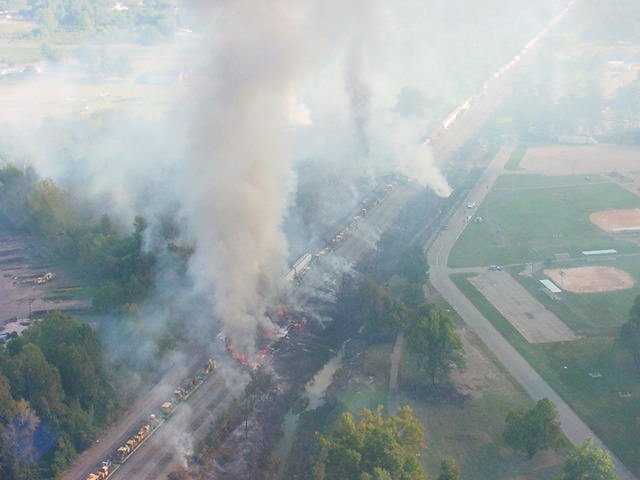 Overhead view of the smoking scene of the train derailment.